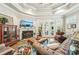 Comfortable living room with fireplace, tufted sofa, and natural light through large windows at 332 Rosshandler Rd, Suwanee, GA 30024