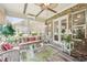 Cozy sunroom featuring wicker furniture, glass coffee table, and an abundance of natural light at 332 Rosshandler Rd, Suwanee, GA 30024