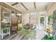Bright sunroom with brick accent wall, wood beam ceiling, and view to backyard at 332 Rosshandler Rd, Suwanee, GA 30024