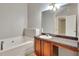 Bathroom featuring a vanity with sink, large mirror, and soaking tub at 4713 Liberty Square Dr, Acworth, GA 30101