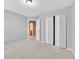 Bedroom featuring bi-fold closet doors, neutral walls, carpet, and a doorway leading to another room at 4713 Liberty Square Dr, Acworth, GA 30101
