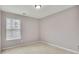 Bright bedroom featuring neutral walls, carpet flooring, a window with blinds, and overhead lighting at 4713 Liberty Square Dr, Acworth, GA 30101