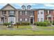Traditional brick townhome featuring a well-maintained lawn and an inviting entrance at 4713 Liberty Square Dr, Acworth, GA 30101