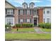 Charming brick townhome with manicured lawn and traditional architectural details at 4713 Liberty Square Dr, Acworth, GA 30101