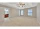 Spacious primary bedroom with tray ceiling, ceiling fan, and natural light at 4713 Liberty Square Dr, Acworth, GA 30101