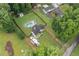 Aerial view showcasing a home with a large backyard, in-ground pool, and surrounding trees at 5745 Westwood Dr, Cumming, GA 30040