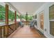 Inviting back porch with wooden floors and comfortable seating for outdoor enjoyment at 5745 Westwood Dr, Cumming, GA 30040