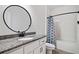 Bathroom featuring granite countertops, modern fixtures, and a shower/tub combo at 5745 Westwood Dr, Cumming, GA 30040