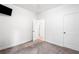 Well-lit bedroom with carpet, fresh paint, and modern door frames at 5745 Westwood Dr, Cumming, GA 30040