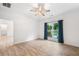 Bedroom with wood-look floors, ceiling fan, and view to the pool at 5745 Westwood Dr, Cumming, GA 30040
