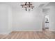Dining room with wood-look floors and modern industrial-style lighting at 5745 Westwood Dr, Cumming, GA 30040
