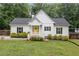 Charming home with a bright yellow door and manicured landscaping at 5745 Westwood Dr, Cumming, GA 30040