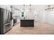 Modern kitchen with stainless appliances, white cabinets, and dark island at 5745 Westwood Dr, Cumming, GA 30040