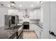 Farmhouse sink and granite countertops in a kitchen with stainless appliances at 5745 Westwood Dr, Cumming, GA 30040