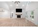 Bright living room with a fireplace, ceiling fan, and view to the outdoor deck at 5745 Westwood Dr, Cumming, GA 30040