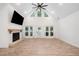 Bright living room featuring a fireplace and large windows, offering plenty of natural light at 5745 Westwood Dr, Cumming, GA 30040