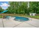 View of private in-ground pool and landscaped backyard, creating a serene and relaxing outdoor oasis at 5745 Westwood Dr, Cumming, GA 30040