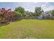 Large, fenced backyard with lush grass and mature landscaping at 1003 Dunedin Trl, Woodstock, GA 30188
