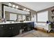 Well-lit bathroom features double sinks, large mirror, and a soaking tub at 1003 Dunedin Trl, Woodstock, GA 30188