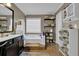 Bright bathroom with storage shelves, soaking tub, and natural light at 1003 Dunedin Trl, Woodstock, GA 30188
