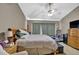Spacious bedroom featuring a ceiling fan and a cozy sitting area at 1003 Dunedin Trl, Woodstock, GA 30188