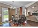 Charming dining area with a dark wood table and adjacent living area at 1003 Dunedin Trl, Woodstock, GA 30188
