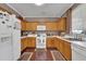 Functional kitchen with oak cabinets, appliances, and ample counter space at 1003 Dunedin Trl, Woodstock, GA 30188