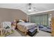 Spacious main bedroom featuring a vaulted ceiling, fan and comfortable furnishings at 1003 Dunedin Trl, Woodstock, GA 30188