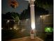 Charming backyard with a wooden fence, landscape lighting, and decorative plants at 106 Cessna Dr, Canton, GA 30114