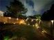 Fenced backyard illuminated by stylish outdoor lighting, creating a serene atmosphere at 106 Cessna Dr, Canton, GA 30114
