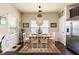 Bright dining area with a stylish light fixture, seating for six, and stainless steel refrigerator at 106 Cessna Dr, Canton, GA 30114