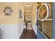 Inviting entryway with hardwood floors, decorative wreath, and white wainscoting at 106 Cessna Dr, Canton, GA 30114