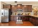 Well-equipped kitchen with stainless steel appliances, dark cabinetry, and granite countertops at 106 Cessna Dr, Canton, GA 30114