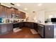 Modern kitchen with dark cabinetry, granite countertops, stainless steel appliances, and hardwood floors at 106 Cessna Dr, Canton, GA 30114