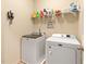 Functional laundry room with modern washer and dryer, and a shelf for laundry supplies at 106 Cessna Dr, Canton, GA 30114