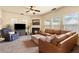 Inviting living room with a fireplace, ceiling fan, and a comfortable leather sectional sofa at 106 Cessna Dr, Canton, GA 30114
