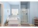 Relaxing main bathroom with a soaking tub, separate glass-enclosed shower, and neutral paint at 106 Cessna Dr, Canton, GA 30114