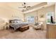 Spacious main bedroom with tray ceiling, ceiling fan, large bed and bedside tables at 106 Cessna Dr, Canton, GA 30114