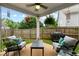 Outdoor patio with comfortable seating, a ceiling fan, and lush greenery in the background at 106 Cessna Dr, Canton, GA 30114