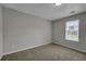 Carpeted bedroom with neutral colors and a window for natural light at 2535 Brookgate Xing, Ellenwood, GA 30294