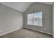 This bedroom features neutral carpet, gray walls, and a bright window at 2535 Brookgate Xing, Ellenwood, GA 30294