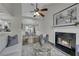 Open-concept living room featuring a fireplace, ceiling fan, and view into the dining area at 2535 Brookgate Xing, Ellenwood, GA 30294