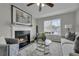 Inviting living room with fireplace, plush seating, and natural light from a large window at 2535 Brookgate Xing, Ellenwood, GA 30294