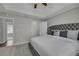 Main bedroom features tray ceiling, carpet, decorative headboard, and walk-in closet at 2535 Brookgate Xing, Ellenwood, GA 30294