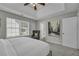 Main bedroom featuring tray ceiling, carpet, view to the backyard, decorative headboard and chair at 2535 Brookgate Xing, Ellenwood, GA 30294