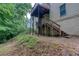 Exterior view of the multi-tiered wood deck, overlooking a natural backyard at 403 Hidden Hills Ct, Canton, GA 30115