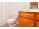 Bright bathroom with white shower curtain, toilet, and wooden cabinet with sink at 403 Hidden Hills Ct, Canton, GA 30115