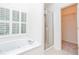 Bright bathroom with a soaking tub, shower and access to a walk-in closet at 403 Hidden Hills Ct, Canton, GA 30115