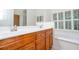 Bathroom featuring a double vanity with wood cabinets, white countertops and a mirror at 403 Hidden Hills Ct, Canton, GA 30115