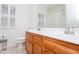 Well-lit bathroom features a double vanity with a wooden cabinet and a white countertop and plenty of storage at 403 Hidden Hills Ct, Canton, GA 30115